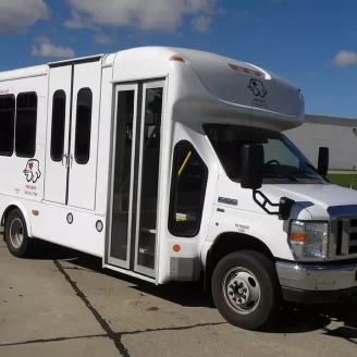 A side view of The We Care Bus, used for transporting the elderly and those with disabilities