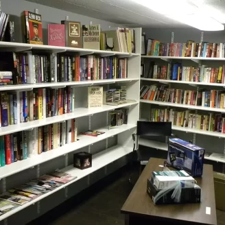Bookshelves with books to buy at Upscale Resale